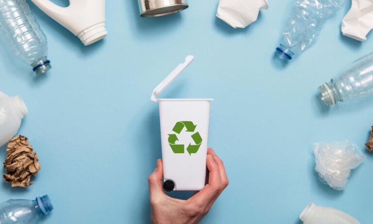 Hand,Holding,A,Recycling,Garbage,Bin,With,Lots,Of,Waste